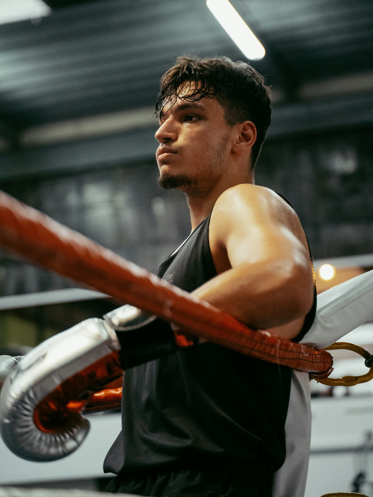 Boxer resting on the ropes between rounds